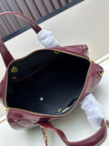 Burgundy patent leather quilted Boston bag